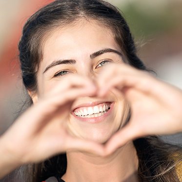 lady making heart with hands